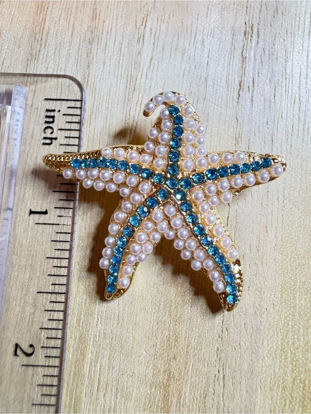 Gold Starfish Brooch with Blue Crystal Accents and Pearl Detail